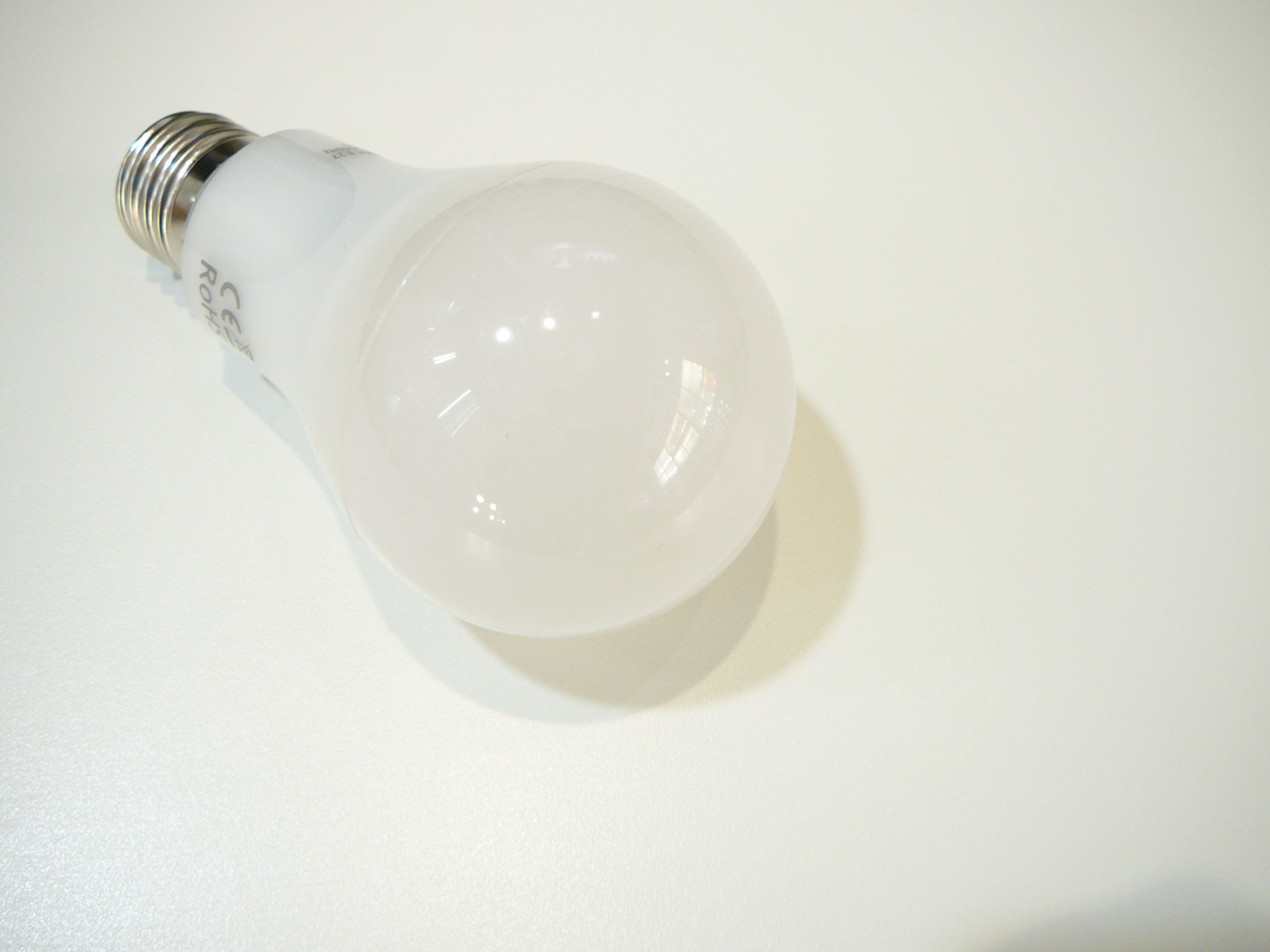 LED žárovka položená na bílém stole